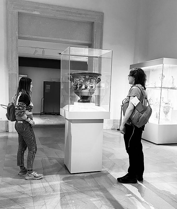 Two students looking at a vase encased in glass at the Met