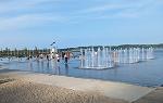 Image of three water fountains inside the infinity pool on Promenade Samuel de Champlain with several people wading around nearby