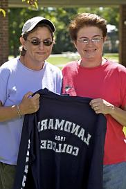 Two women at Landmark College holding a Landmark College t-shirt